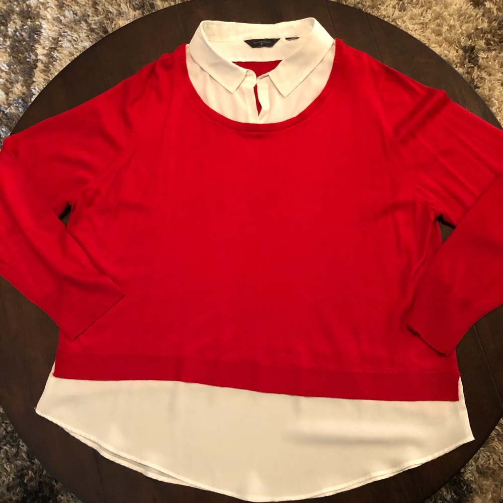 Women’s red sweater, white blouse collar and hem
